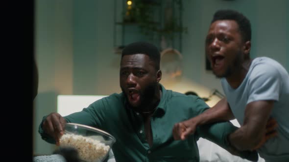 Black Spectators Celebrating Team Victory at Home alt