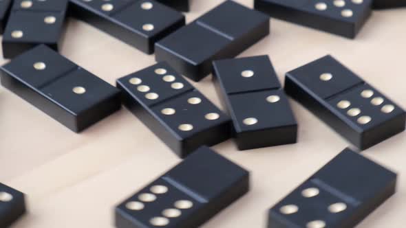 Domino Dice Black with White Dots Rotating Around on Wooden Background alt