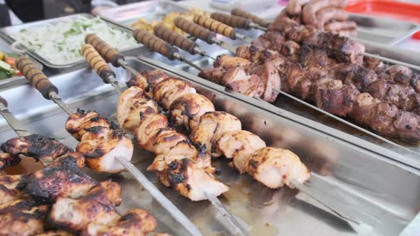 Grilled Vegetables and Meat in Street Shop Window. Food Court with Grilled Meals alt