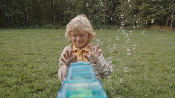 Shooting Soap Bubbles at Boy alt