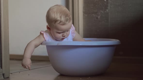 Cute Baby Girl in a Round Blue Tub 3 alt