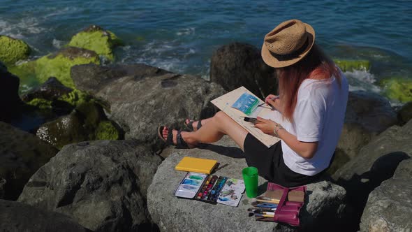 Art Hobby of Young Woman in Summertime Artist is Painting Seascape From Nature alt