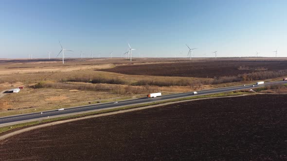 Highway on the Background of Wind Turbines and Blue Sky