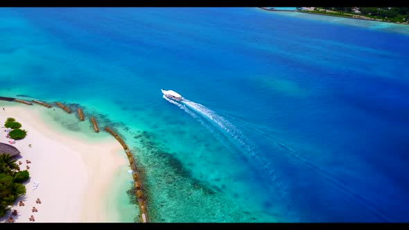 Aerial top down seascape of luxury shore beach journey by clear lagoon with white sand background of alt