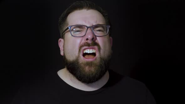 Motion studio portrait of a bearded man expressing anger and rage alt