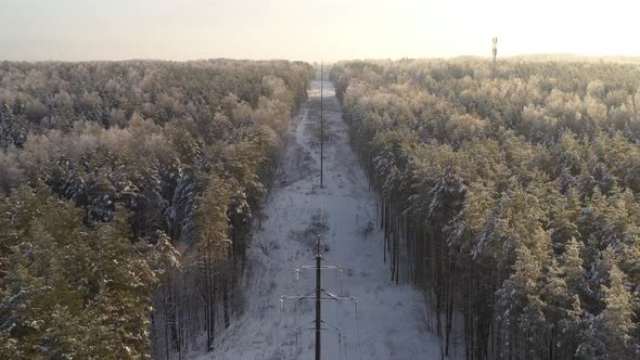 AERIAL: Flying Above Power Electricity Cable Lines on a Cold Winter Day 
