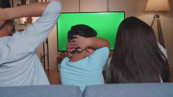 Asian Family Is Frustrated About The Loss Of The Team In Game They Are Watching Tv With Green Screen alt