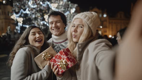 Happy Three Friends Taking Selfie at Xmas Night alt