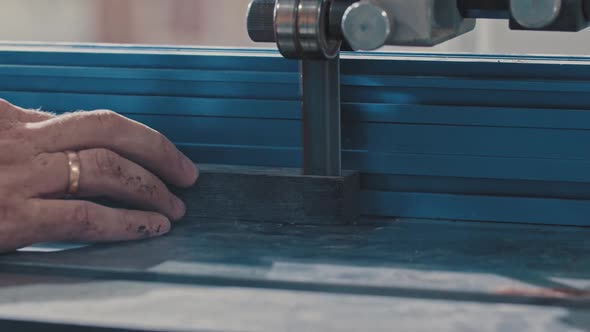 Carpentry Works Worker Slowly Cutting Along the Wooden Detail with an Automatic Saw Making It Two alt