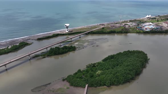 Anaklia, Georgia - July 16 2022: Aerial view of Anaklia-Ganmuhkuri Pedestrian Bridge at sunset alt