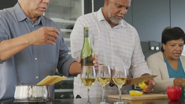 Happy senior diverse people cooking in kitchen at retirement home alt