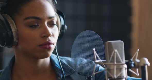 Sound Record Industry. African American Female Singer Recording New Song at Professional Room alt