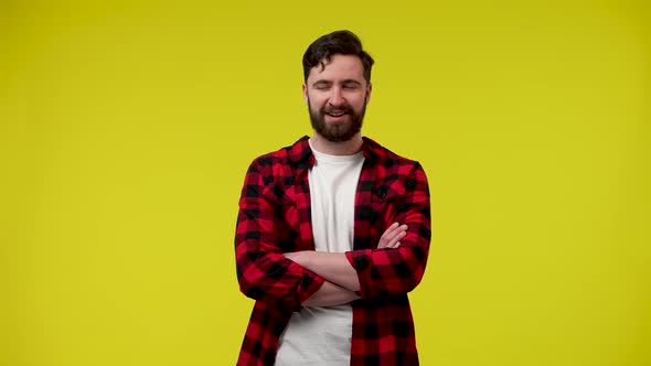 Portrait of a Stylish Bearded Man in the Studio on a Yellow Background alt