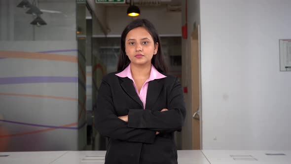 Confident Female Indian entrepreneur standing crossed hands alt
