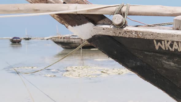 African Traditional Wooden Boat Stranded in Sand on Beach at Low Tide Zanzibar alt