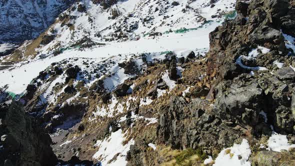 Herd of Mountain Goats Running Down the Southern Slope of Elbrus alt