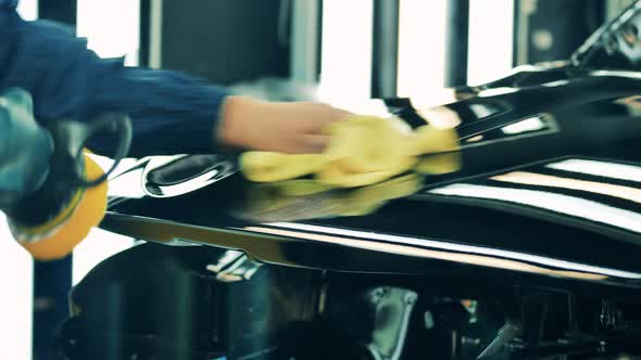 Car Factory Worker Polishing a Car Body alt