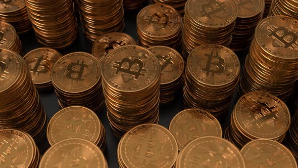 Bitcoins stacked on glossy black background alt