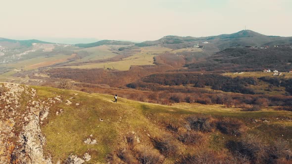Tracking View Woman Hiking Solo Downhill In Beautiful Pristine Nature alt