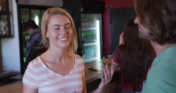 Friends at the bar in a pub having fun alt