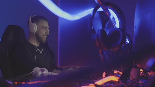 Player in Headphones Wining Online Shooter alt