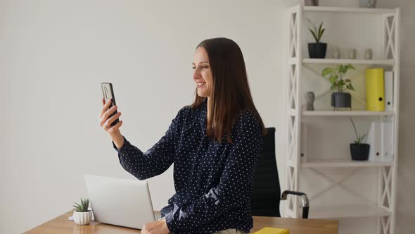 Modern Young Businesswoman is Using Smartphone for Video Call alt