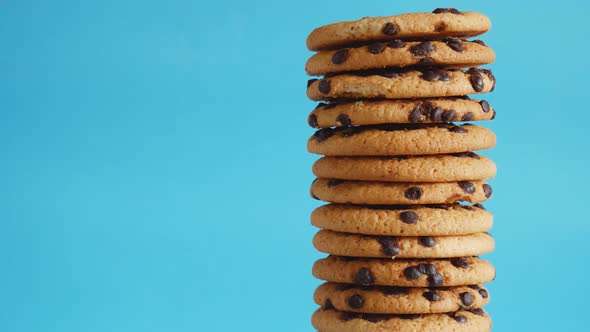 A Stack Chocolate Chip Cookies Rotate on a Blue Background alt