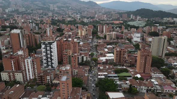 Tilting down, Aerial View of large city and traffic in the mountains, Medellin, Colombia alt
