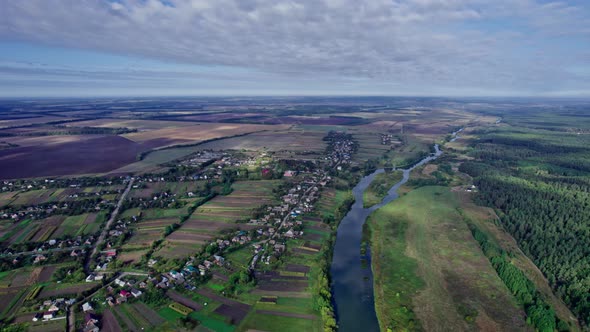 Drone Shot of Landscape with River and Field alt