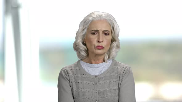 Senior Woman with Thoughtful Expression. alt