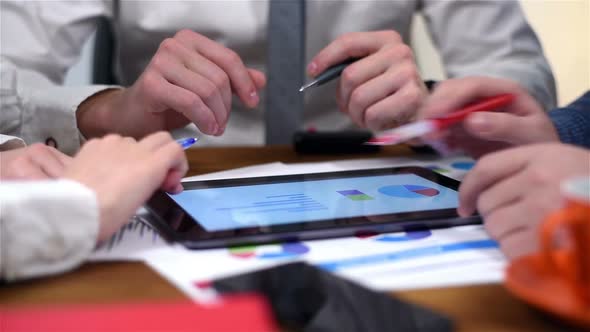 Three Businesspeople Using Touch Pad