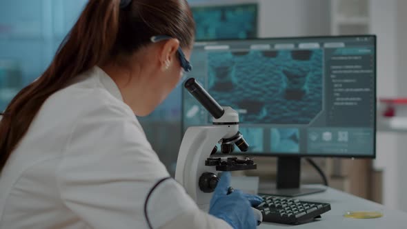 Biology Scientist Working with Microscopic Tool in Laboratory alt