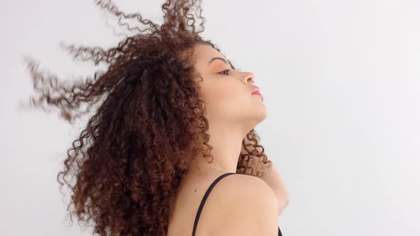 Mixed Race Black Woman with Freckles and Curly Hair in Studio in Profile To a Camera