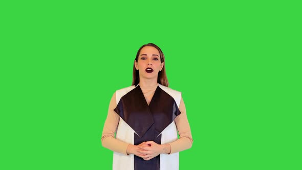 Robotic Girl Stands Looking in Camera Saying Something Fast on a Green Screen Chroma Key