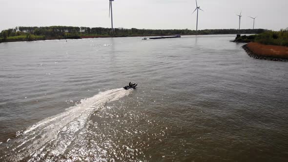 Aerial Tracking Shot Of Speedboat Travelling Across Calm Waters Of Oude Maas alt