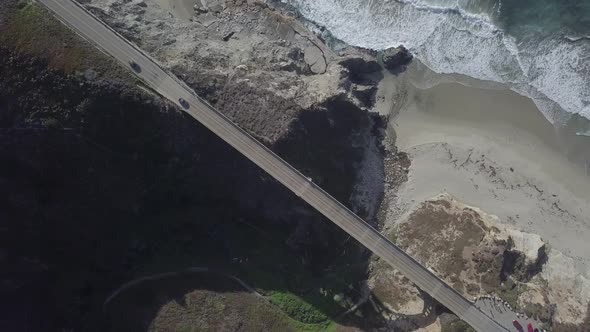 Aerial Drone Shot of Bixby Bridge with Road and Ocean alt