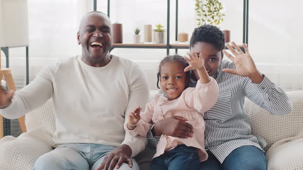 African Afro Family Happy Parents and Little Black Child Girl Sitting at Home Sofa Laughing Loudly alt