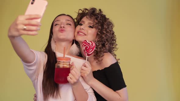 Two Best Friends Taking Selfie and Posing on Camera