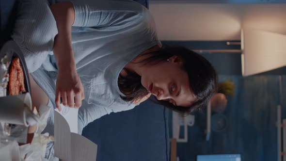 Vertical Video Annoyed Desperate Young Woman Sitting on Sofa Reading Eviction Notice alt