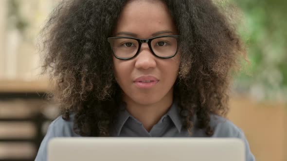 Close Up of African Woman with Laptop Smiling at the Camera alt