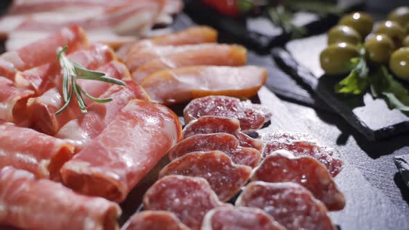 Salami and Chorizo Sausage Close Up on Dark Concrete Background alt