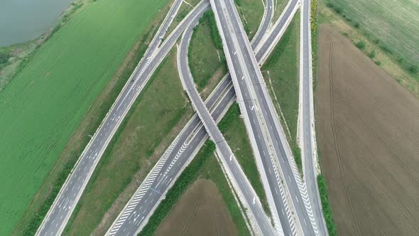 Aerial high drone flight over Highway and overpass. Road junction alt