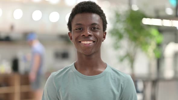 Smiling Young African Man Looking at Camera alt
