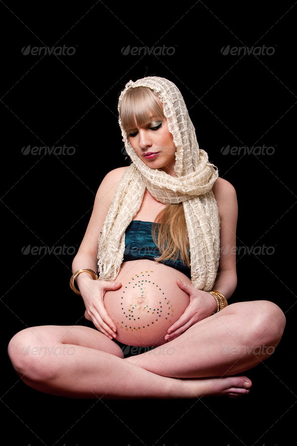 Pregnant woman holding belly - Stock Photo - Images