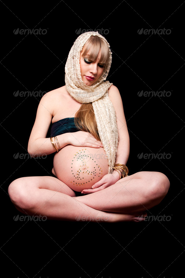 Pregnant woman holding belly - Stock Photo - Images