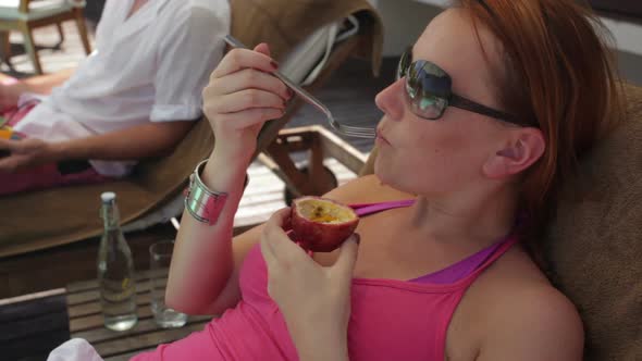 Woman Eating Passion Fruit