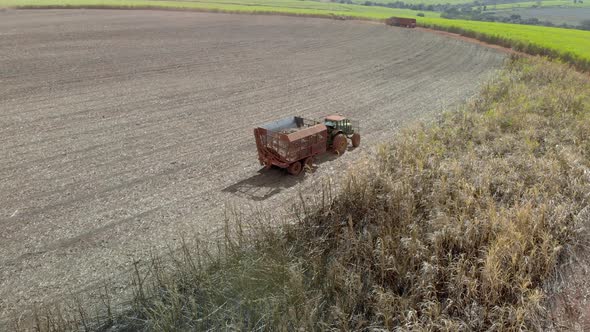 Closeup variety of shots showing harvesting machine cutting down ripe sugarcane crop ready to be tra alt
