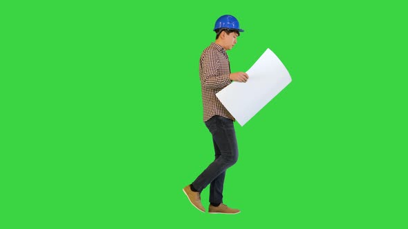 Engineer Walking and Looking at Blueprint on a Green Screen Chroma Key alt