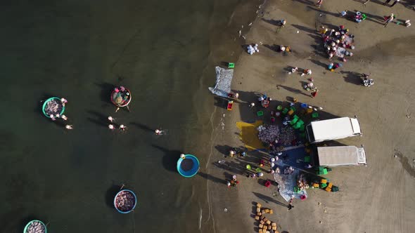 Aerial View Looking Directly Down with Vietnamese People Fishing Along Mui Ne Beach in Vietnam. alt