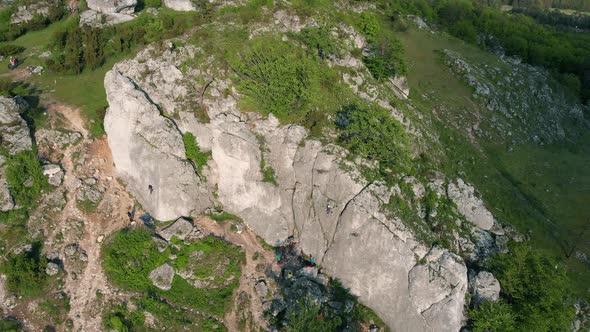 People Climbing A Rock Face